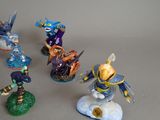five figurines of different characters on a gray surface