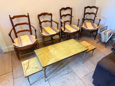 several chairs and a table in a room with a couch