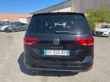 the back of a black vw van parked in a parking lot