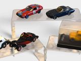 four different models of cars on display in a display case