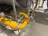 a yellow pipe attached to the side of a boat