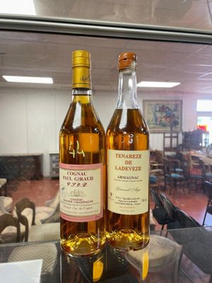 two bottles of wine sitting on a table in a restaurant