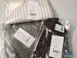 two shirts and a pair of pants wrapped in plastic