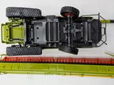a green tractor and a green combiner on a white surface