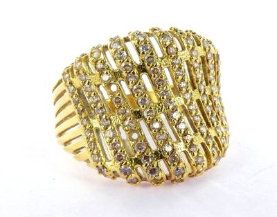 a close up of a gold ring with diamonds on a white surface