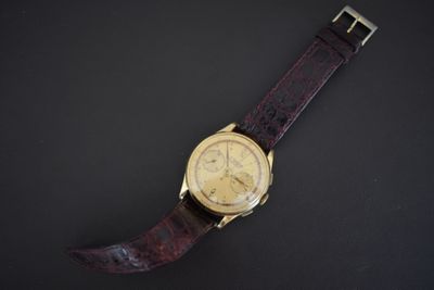 an image of a wrist watch on a black surface