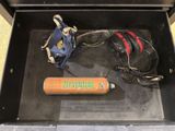 a bat and a bag in a box on the floor