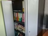 an image of a room with a bookcase and a desk