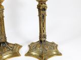 pair of antique brass candlesticks on a white background