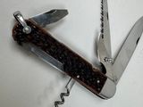 a small swiss army knife with a corkscrew on it