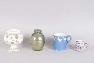 four different types of vases are lined up on a gray surface
