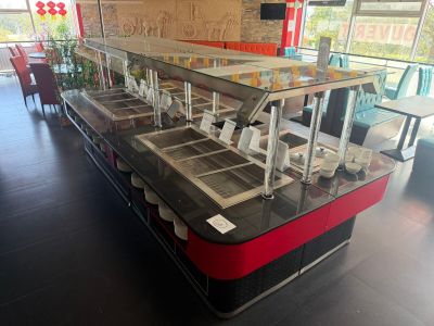 tables and chairs in a restaurant with a glass counter top