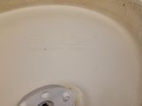a white toilet bowl with a white lid on a tiled floor