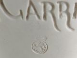 a close up of a white vase with the word garrii written on it