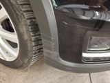 a close up of a car ' s front bumper and tire