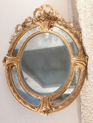 a mirror hanging on the wall next to a wall