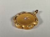an image of a gold locke with a diamond in the center