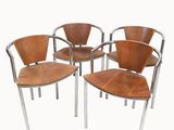 four wooden chairs with chrome steel legs and a wooden seat