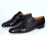 a pair of black shoes on a white surface