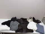 une table blanche sur laquelle sont posés des vêtements et une paire de chaussures