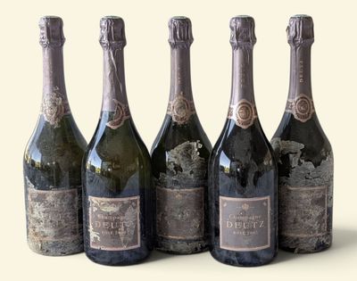 four bottles of wine are lined up in a row