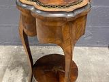 an image of a wooden table with a marble top on a concrete floor