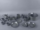 un assortiment d'articles en étain, comprenant notamment des tasses, des soucoupes et des soucoupes