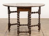 an old wooden table with a wooden top on a wooden floor