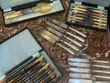 a lot of knives that are sitting on a table