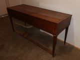 a wooden desk with a mirror on top of it