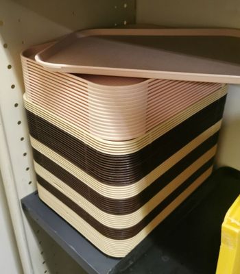 a stack of plastic containers on a shelf in a closet