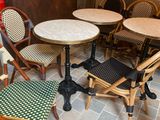 several chairs and tables in a room with a brick wall