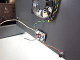 a fan that is attached to a wall in a room
