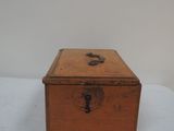a small wooden box with a lock on it