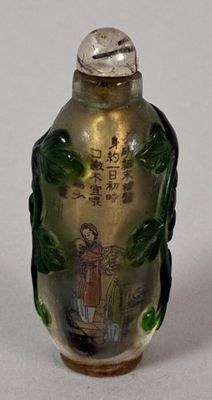 a small glass bottle with a painting on it