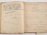 an open book with writing on it sitting on a table