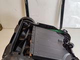 a close up of a black and green robot on a table