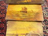 three wooden tables with paintings on them sitting on a rug