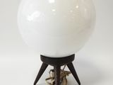 a white ball on a wooden stand with a rope around it