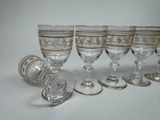 six wine glasses sitting next to each other on a table