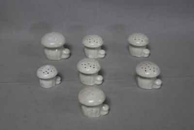 a lot of small white mushrooms sitting on a table