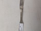 a fork with a tag on it sitting on a table