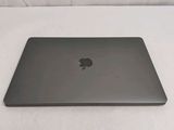 a black apple laptop sitting on a white surface