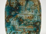 a close up of a blue stone object on a white surface
