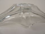 a clear glass candle holder on a white table