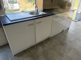 a kitchen with a sink and a window in it