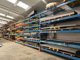 many shelves in the warehouse with many items on them