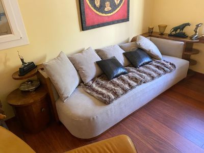 a living room with a white couch and a wooden table