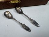 two spoons sitting next to each other on a table