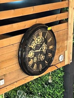 a clock that is on the side of a wooden box